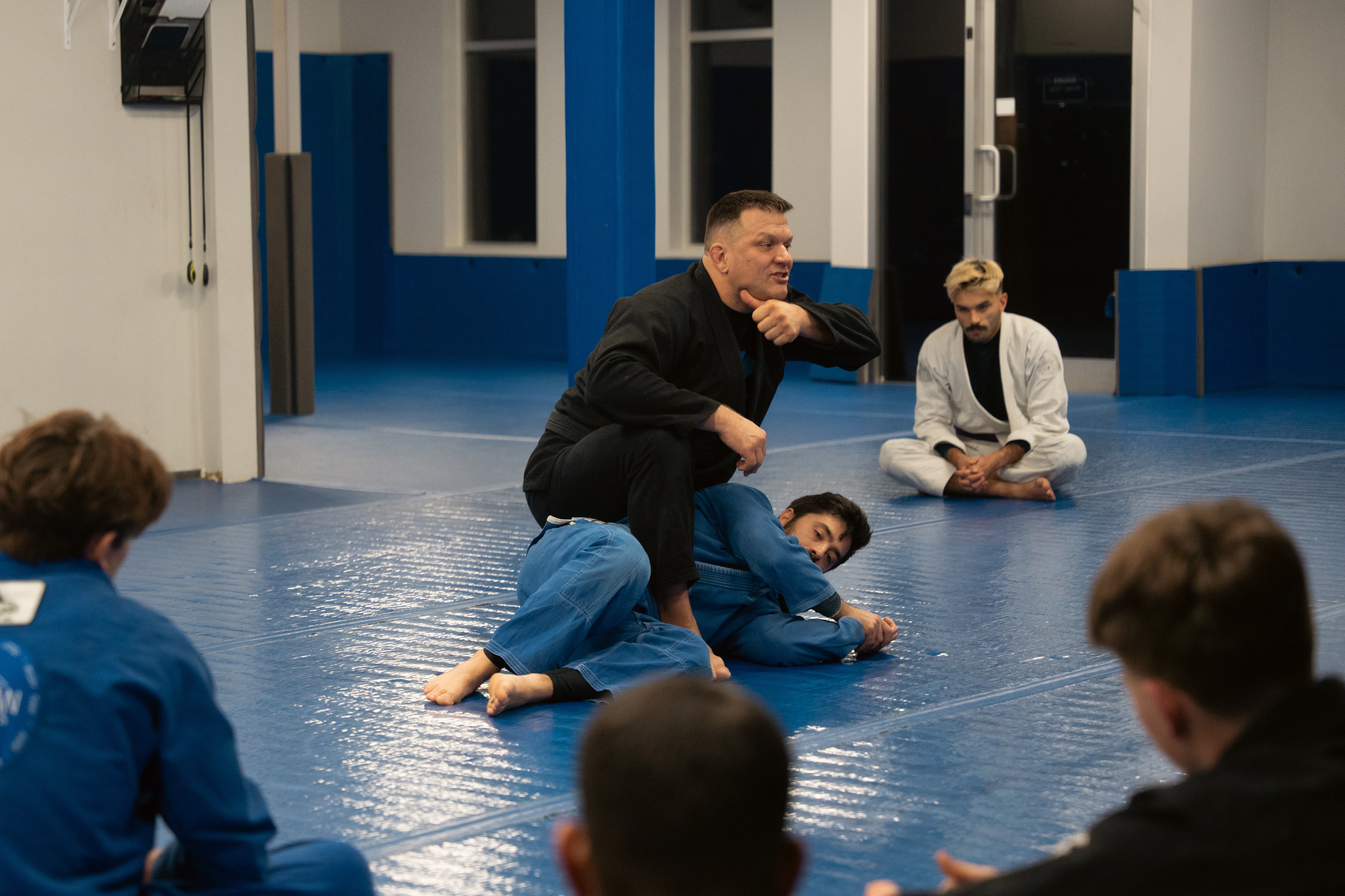 Coach demonstrating Brazilian Jiu-Jitsu technique at Pacific Top Team Penticton