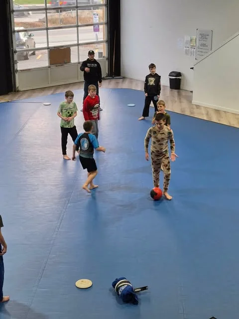 Kids playing an active group game on the mats at Pacific Top Team Penticton