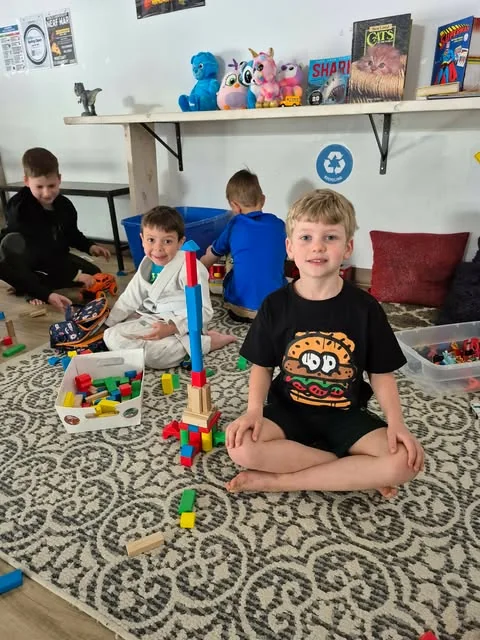 Kids relaxing and playing during snack and downtime at Pacific Top Team Penticton