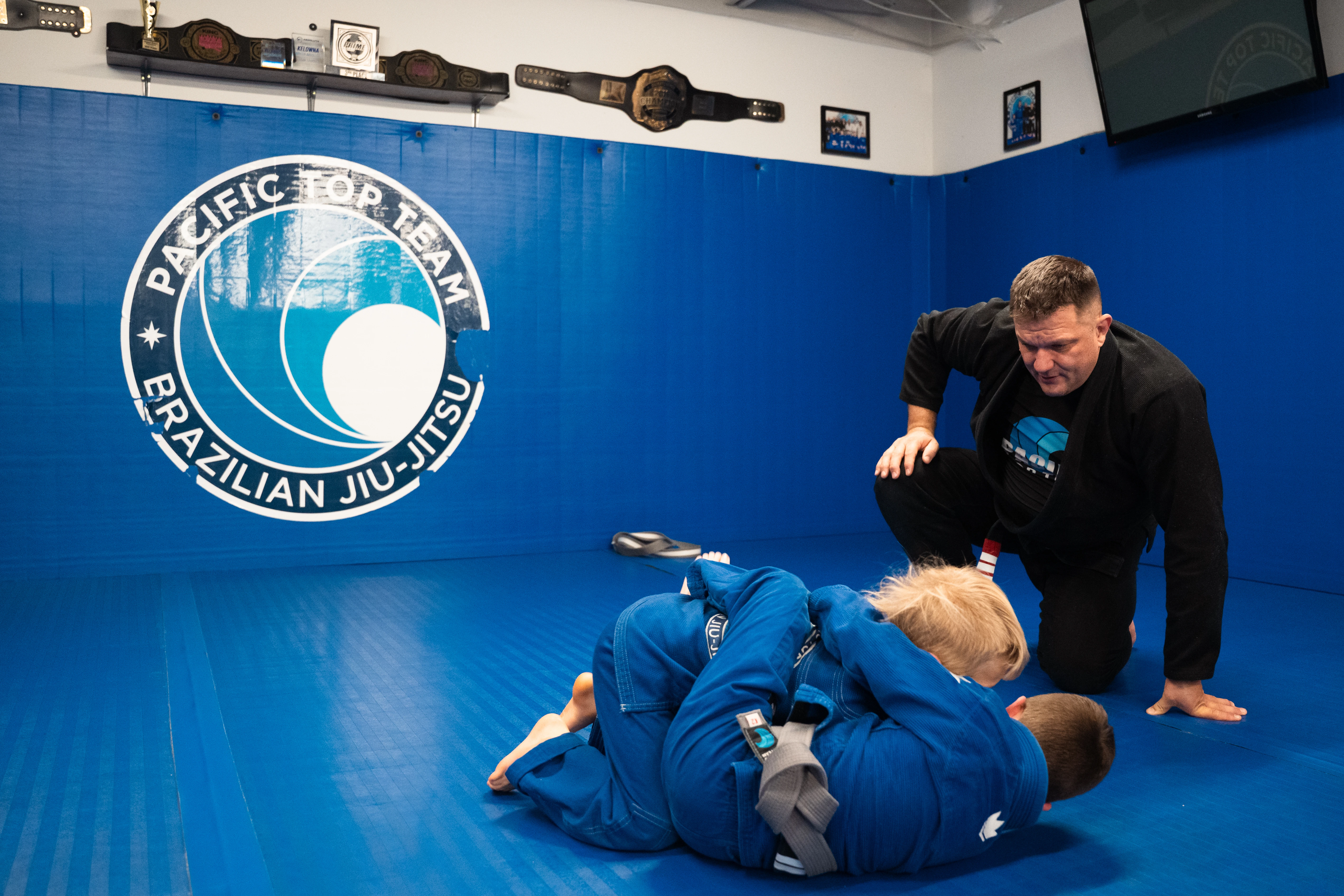 Coach supervising kids Jiu-Jitsu training at Pacific Top Team Penticton