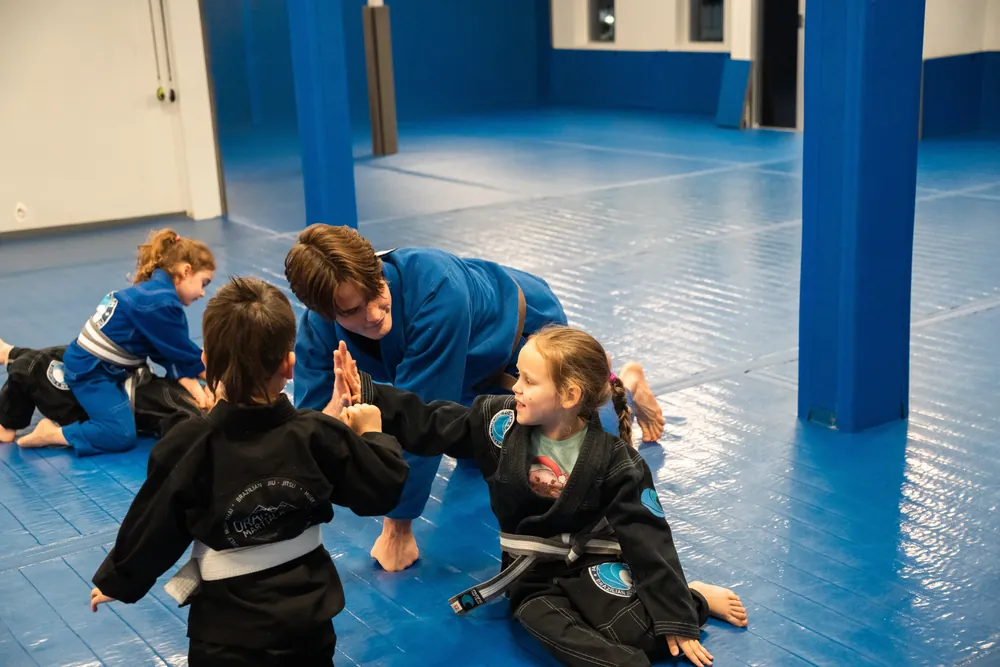 Young students high-fiving during a Tiny Champions Jiu-Jitsu class at Pacific Top Team Penticton